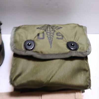 Military issued pouches and bags Ammunition with a canteen and first aid kit.