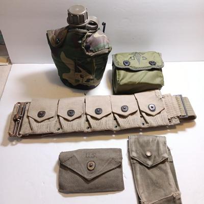 Military issued pouches and bags Ammunition with a canteen and first aid kit.