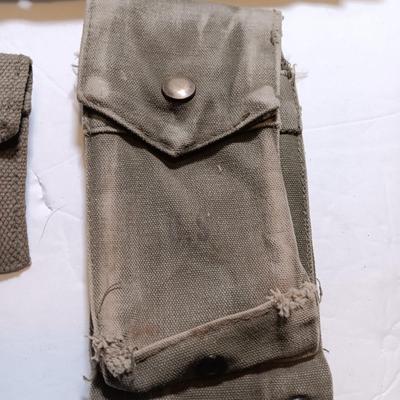 Military issued pouches and bags Ammunition with a canteen and first aid kit.