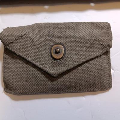 Military issued pouches and bags Ammunition with a canteen and first aid kit.