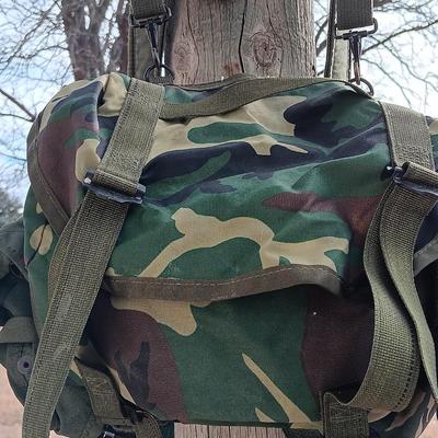 Military issued suspenders with a canteen and an assortment of pouches for ammo and magazines and more.