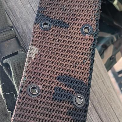 Military issued suspenders with a canteen and an assortment of pouches for ammo and magazines and more.