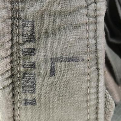 Military issued suspenders with a canteen and an assortment of pouches for ammo and magazines and more.