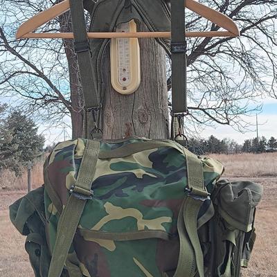 Military issued suspenders with a canteen and an assortment of pouches for ammo and magazines and more.
