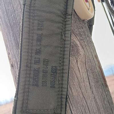 Military issued suspenders with a canteen and an assortment of pouches for ammo and magazines and more.