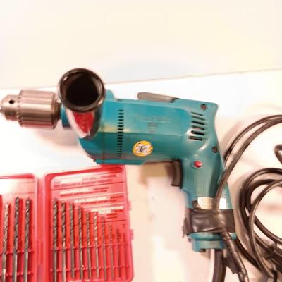 Makita 1/2" electric drill with assortment of drill bits