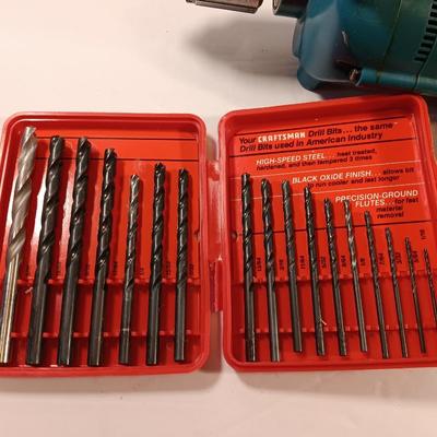 Makita 1/2" electric drill with assortment of drill bits