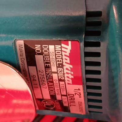 Makita 1/2" electric drill with assortment of drill bits