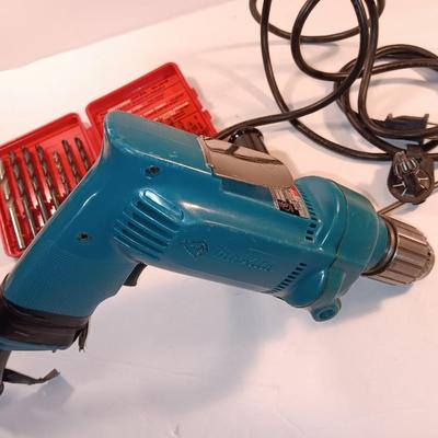 Makita 1/2" electric drill with assortment of drill bits