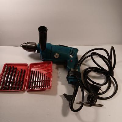 Makita 1/2" electric drill with assortment of drill bits