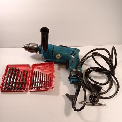 Makita 1/2" electric drill with assortment of drill bits