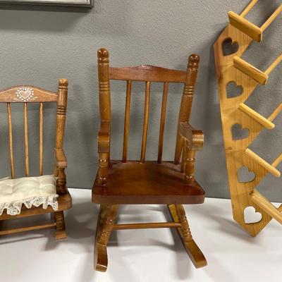Multiple wood doll chairs and display wall hangings