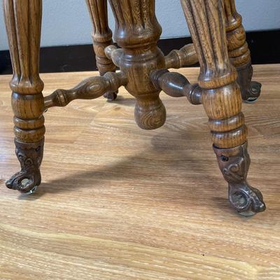 Small stool with swivel seat and claw foot feet