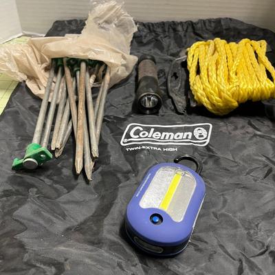 Coleman Bag, Stakes, Rope, and 2 Flashlights