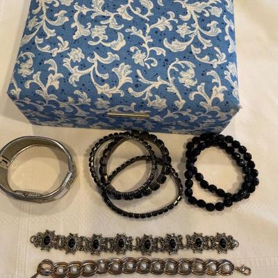 Blue jewelry box with bracelets and watch