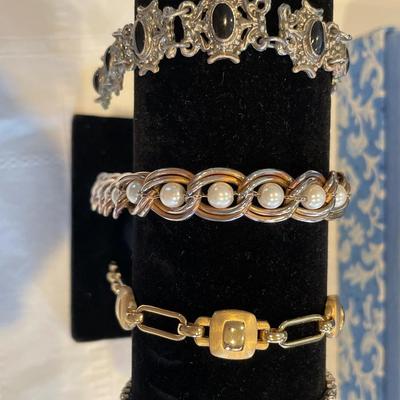 Blue jewelry box with bracelets and watch