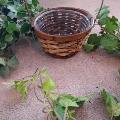 Faux ivy vines with basket of faux greenery and two wicker baskets