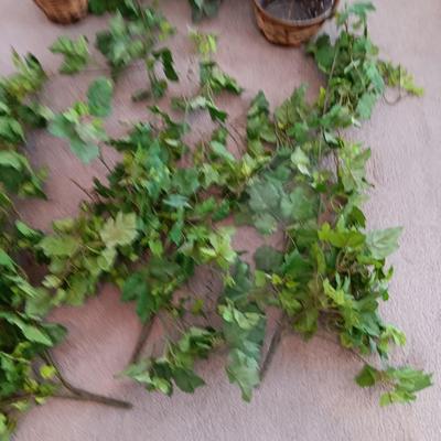 Faux ivy vines with basket of faux greenery and two wicker baskets