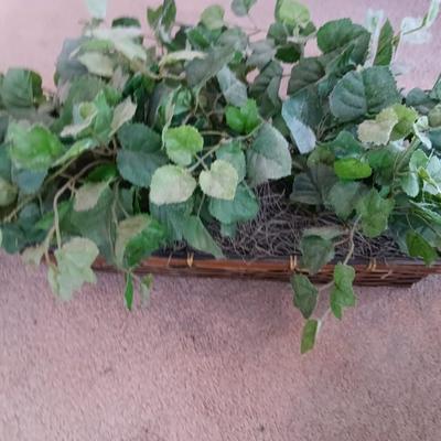 Faux ivy vines with basket of faux greenery and two wicker baskets