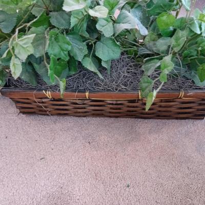 Faux ivy vines with basket of faux greenery and two wicker baskets