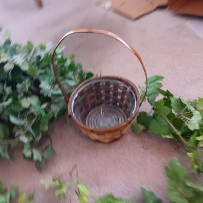 Faux ivy vines with basket of faux greenery and two wicker baskets