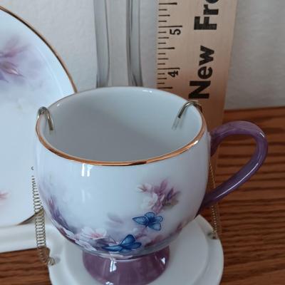 Matching butterfly cup & Saucer set with display base and a glass vase.