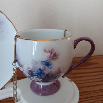 Matching butterfly cup & Saucer set with display base and a glass vase.