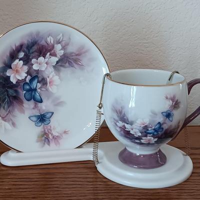 Matching butterfly cup & Saucer set with display base and a glass vase.