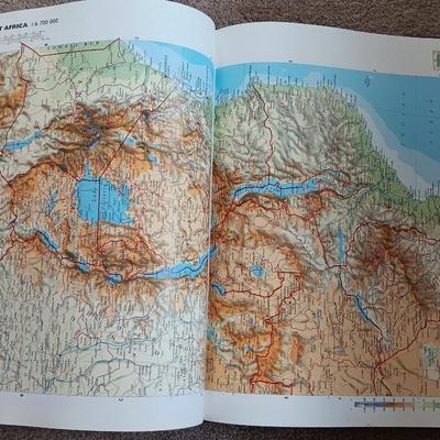 Two coffee table books - Great World Atlas and A Day in the life of America