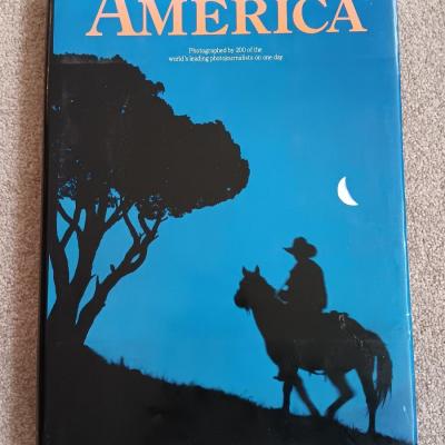 Two coffee table books - Great World Atlas and A Day in the life of America