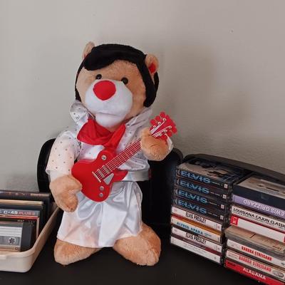 Plush Elvis singing bear with Elvis cassettes and other cassettes.