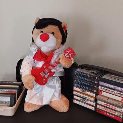 Plush Elvis singing bear with Elvis cassettes and other cassettes.