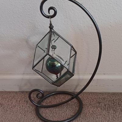 Metal framed display with glass prism and friendship ball and a hand painted floral vase