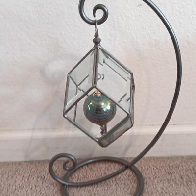 Metal framed display with glass prism and friendship ball and a hand painted floral vase