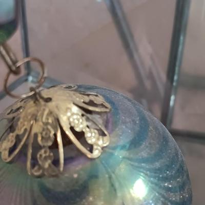 Metal framed display with glass prism and friendship ball and a hand painted floral vase