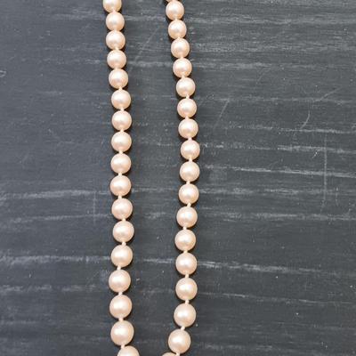 Three necklaces - two faux pearl beaded and one lightweight long chain.