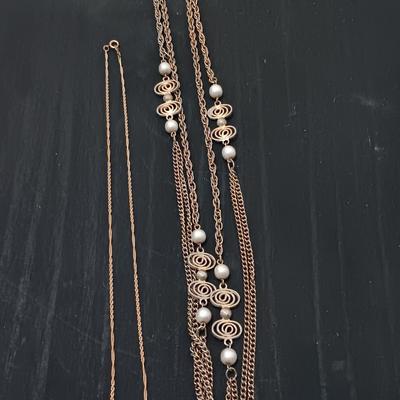 Two gold toned necklaces.