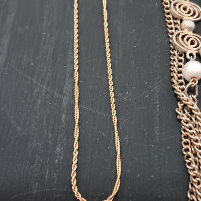 Two gold toned necklaces.