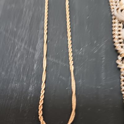 Two gold toned necklaces.