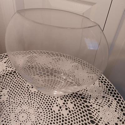 Small covered accent table with vintage lamp and glass vase