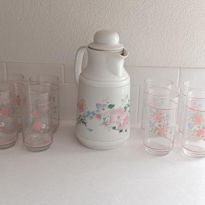 Floral pattern insulated Pheonix carafe with eight Libby pink floral drinking glasses.
