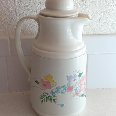 Floral pattern insulated Pheonix carafe with eight Libby pink floral drinking glasses.