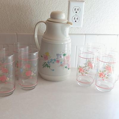 Floral pattern insulated Pheonix carafe with eight Libby pink floral drinking glasses.