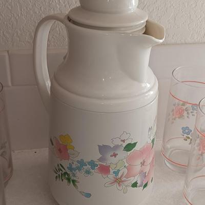 Floral pattern insulated Pheonix carafe with eight Libby pink floral drinking glasses.
