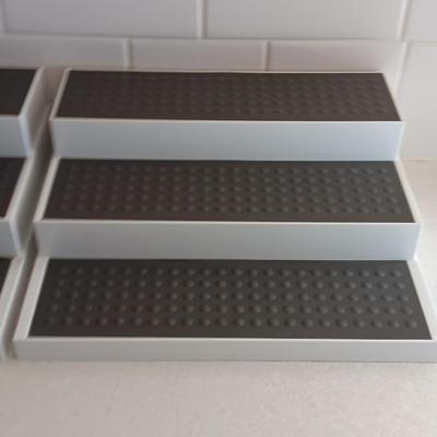 Two cupboard organizing platforms for spices and metal salt & pepper shakers