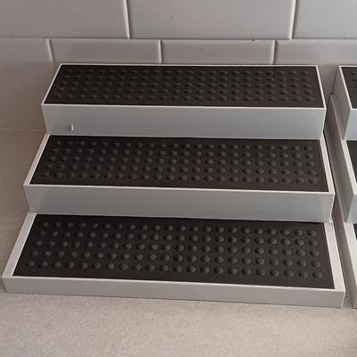 Two cupboard organizing platforms for spices and metal salt & pepper shakers