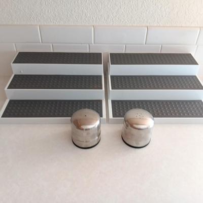 Two cupboard organizing platforms for spices and metal salt & pepper shakers