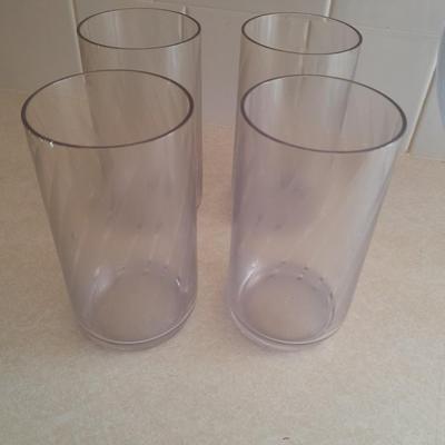 Water pitcher with four glasses and four Rubbermaid plastic plates