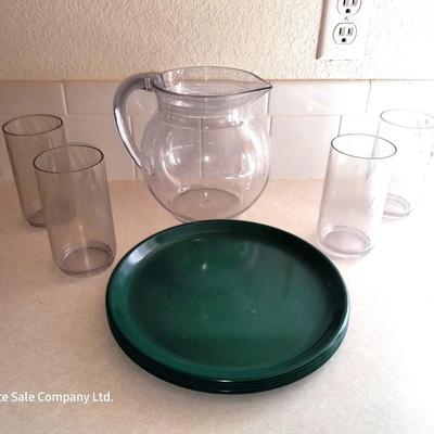 Water pitcher with four glasses and four Rubbermaid plastic plates