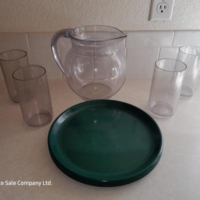 Water pitcher with four glasses and four Rubbermaid plastic plates